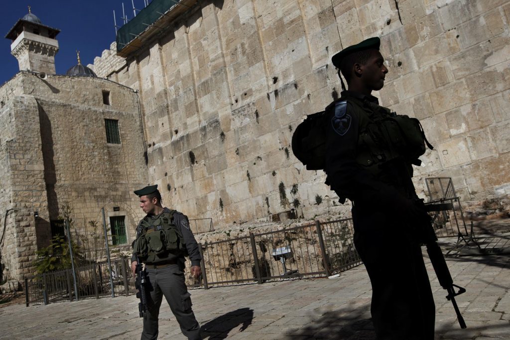 In this Monday, Jan. 14, 2013 file photo, Israeli border police stand guard on the site known to Jews as the Tomb of the Patriarchs, and to Muslims as the Ibrahimi Mosque, in the West Bank city of Hebron