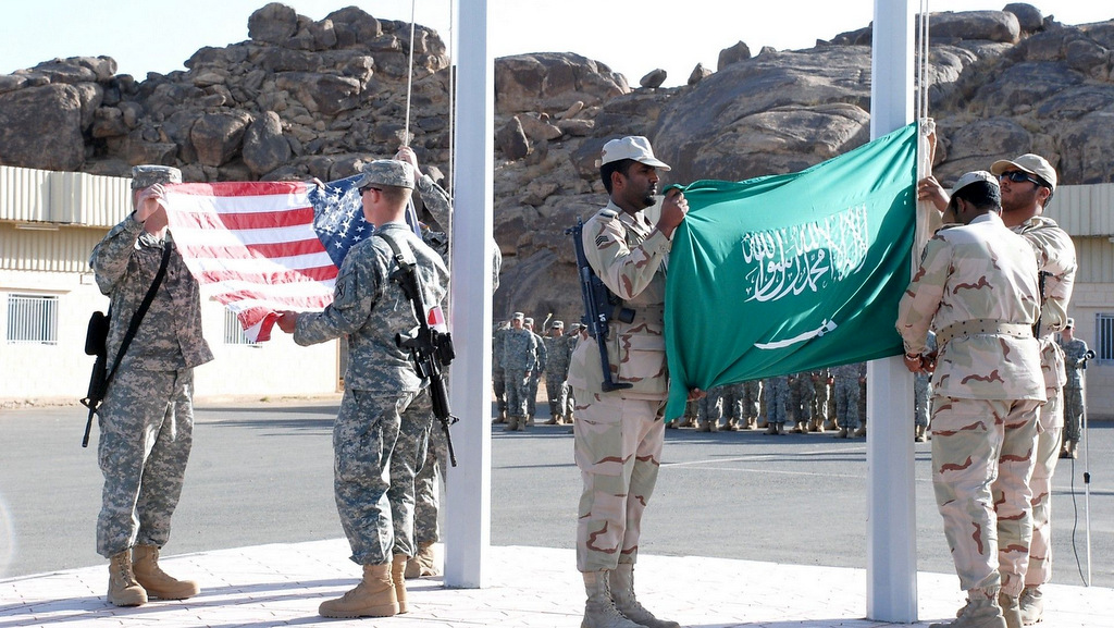 Soldiers from Third Army/U.S. Army Central (Third Army), the South Carolina Army National Guard and the Kingdom of Saudi Arabia Royal Saudi Land Forces (RSLF) lower their country’s respective flags Feb. 28 to commemorate the success of Exercise Friendship Two. (U.S. Army Photo)
