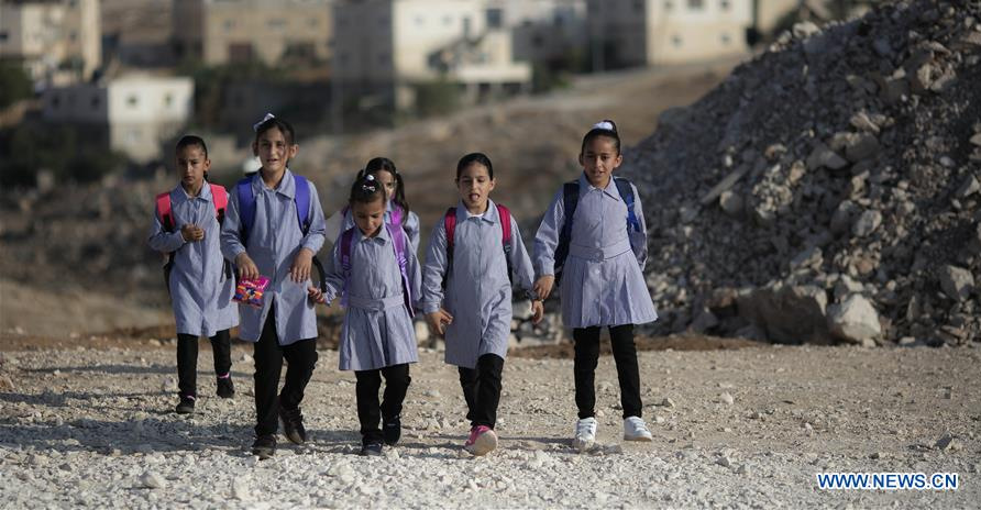 Palestinian children walk to attend a lesson after IDF confiscated caravans used as classrooms in Gaza, Palestine.