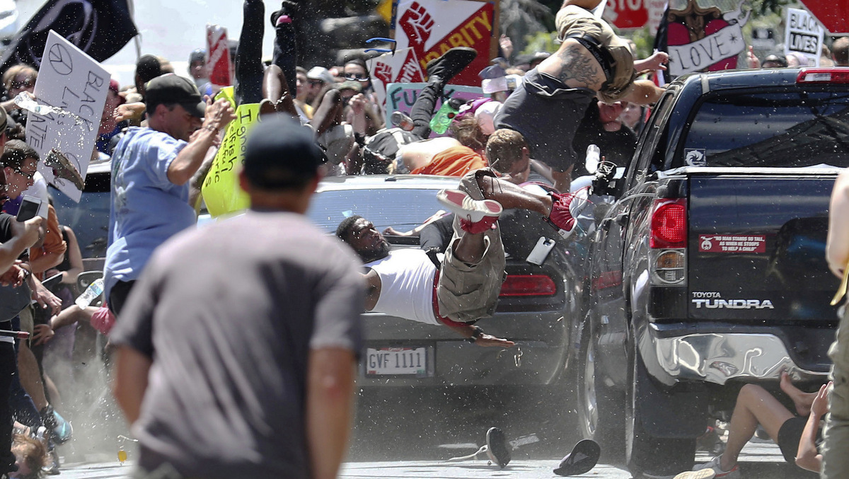 People fly into the air as a vehicle drives into a group of protesters demonstrating against a white nationalist rally in Charlottesville, Va., Aug. 12, 2017. The nationalists were holding the rally to protest plans by the city of Charlottesville to remove a statue of Confederate Gen. Robert E. Lee. There were several hundred protesters marching in a long line when the car drove into a group of them. (Ryan M. Kelly/The Daily Progress)