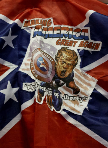 A man holds a Confederate flag with a depiction of Republican presidential candidate Donald Trump during a campaign rally at the Jacksonville Equestrian Center, Nov. 3, 2016, in Jacksonville, Fla. (AP/ Evan Vucci)