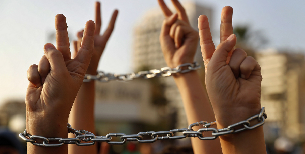 Palestinian boys raise up their hands with chains, during a protest to show their solidarity with hunger striking Palestinian prisoners in Israeli jails, who have been on an open-ended hunger strike for the past 18 days, in Beirut, Lebanon, Thursday, May 4, 2017. (AP Photo/Hussein Malla)