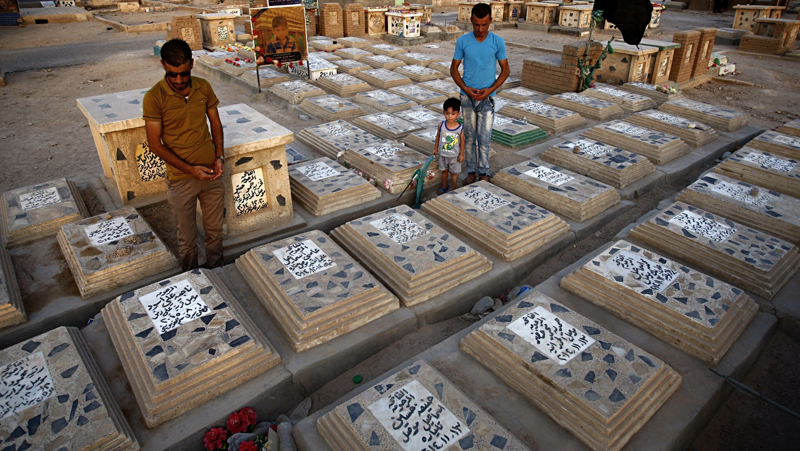 Men pray at a cemetery for Shia volunteer fighters killed fighting with ISIS militants in the Wadi al-Salam, or "Valley of Peace" cemetery in Najaf, 100 miles (160 kilometers) south of Baghdad, Iraq. (AP/Anmar Khalil)