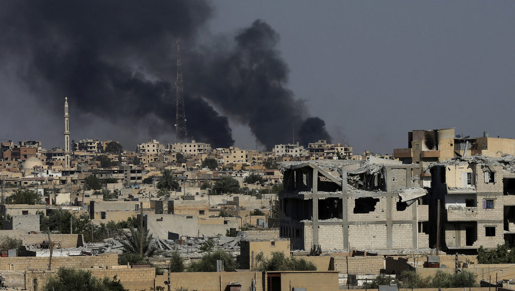 Black smoke rises from Raqqa where U.S.-forces are battling ISIS militants, in, northeast Syria, Thursday, July 27, 2017. (AP/Hussein Malla)