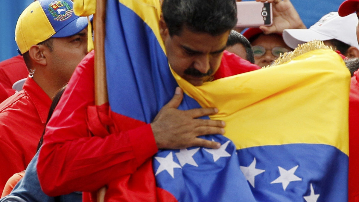 Venezuela's President Nicolas Maduro holds the country's national flag during a rally in Caracas, Venezuela, July 27, 2017. (AP/Ariana Cubillos)