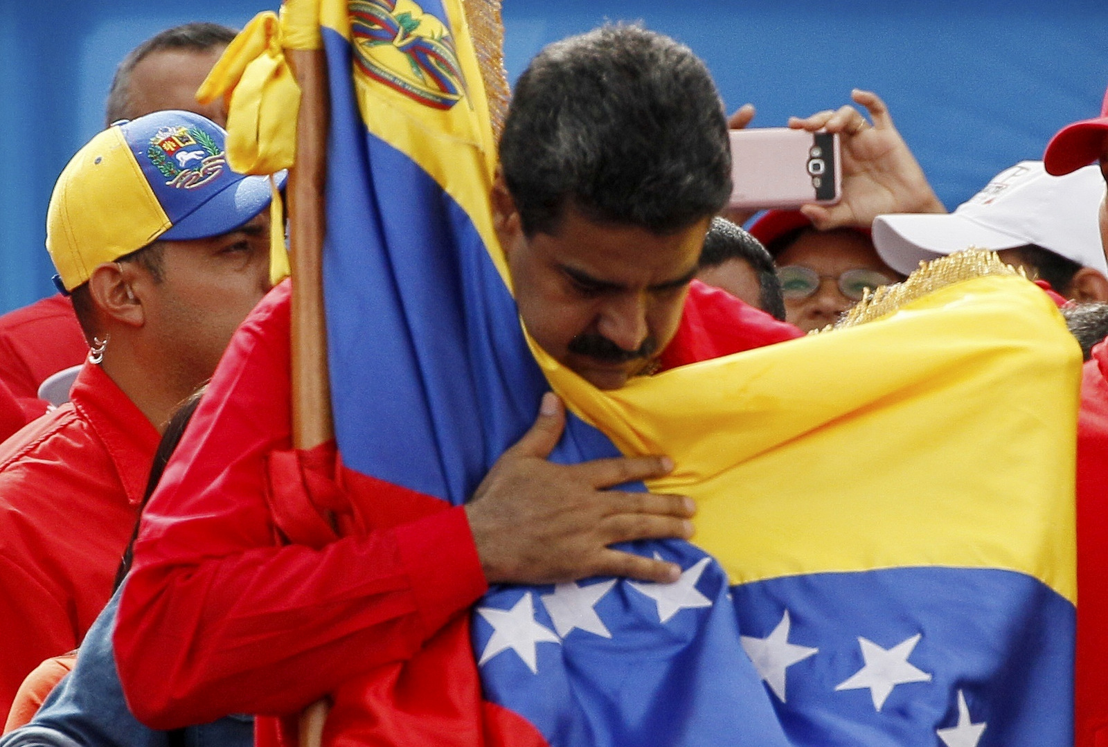 Venezuela's President Nicolas Maduro holds the country's national flag during a rally in Caracas, Venezuela, July 27, 2017. (AP/Ariana Cubillos)