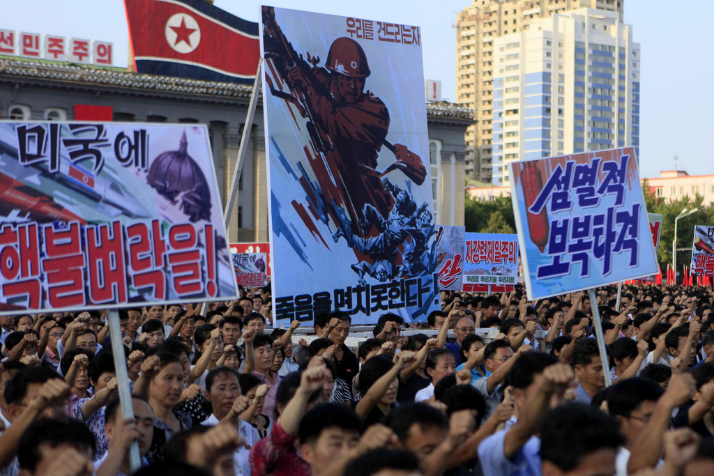 Tens of thousands of North Koreans gathered for a rally at Kim Il Sung Square carrying placards and slogans as a show of support for their rejection of the United Nations' latest round of sanctions on Aug. 9, 2017, in Pyongyang, North Korea. (AP/Jon Chol Jin)