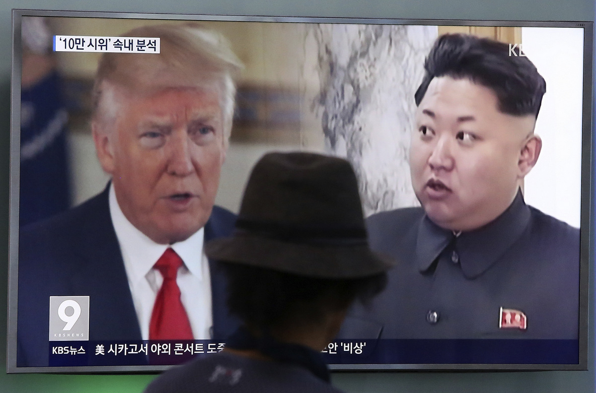 A man watches a television screen showing President Donald Trump and North Korean leader Kim Jong Un during a news program at the Seoul Train Station in Seoul, South Korea, Aug. 10, 2017. (AP/Ahn Young-joon)
