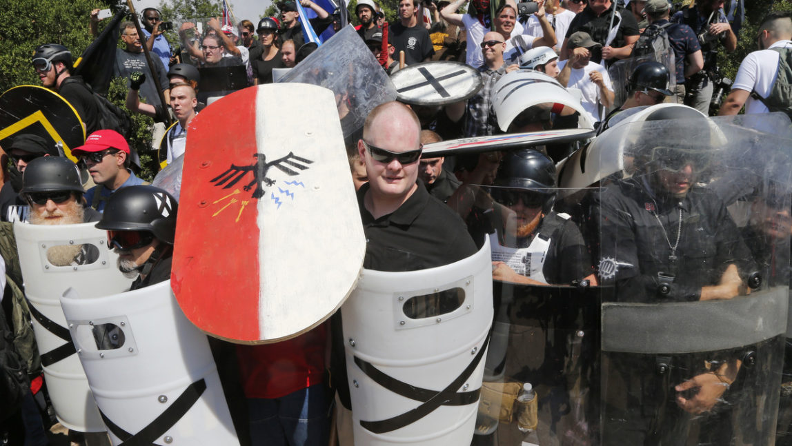 White nationalist demonstrators use shields as they guard the entrance to Lee Park in Charlottesville, Va., Aug. 12, 2017. (AP/Steve Helber)