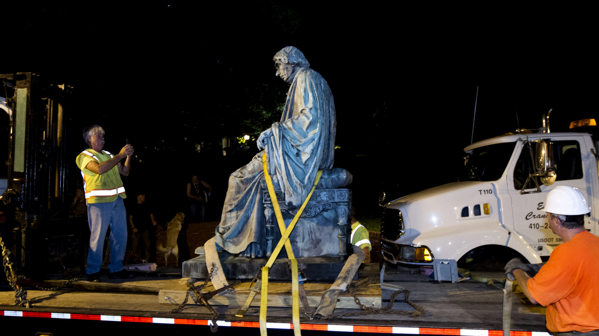 Workers strap down the monument dedicated to U.S. Supreme Court Chief Justice Roger Brooke Taney on a flatbed truck after it was removed from outside the Maryland State House, in Annapolis, Md., early Friday, Aug. 18, 2017. Maryland workers hauled several monuments away, days after a white nationalist rally in Charlottesville, Virginia, turned deadly. ( AP/Jose Luis Magana)