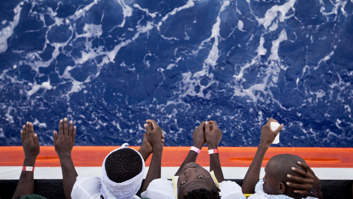 African migrants stand on the deck of the Aquarius vessel of "SOS Mediterranee" and MSF (Doctors Without Borders) NGOs, in the Mediterranean Sea, southwest of Malta, Thursday, Aug. 31, 2017. 265 people rescued from the sea during previous days are being transferred to Italy. (AP/Darko Bandic)