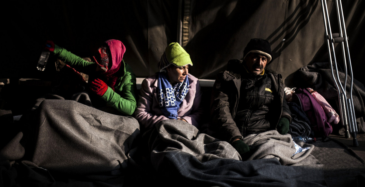 Syrian refugees are seen within a tent at the railway station of Sid, where Serbian authorities load trains with refugees to Crotia. Sid, Serbia, Friday, Nov. 6, 2015 (AP/Manu Brabo)