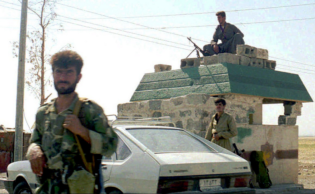 Kurdish guerrillas of the Kurdistan Democratic Party, guard the entrance of Irbil, Iraq, Sept. 1, 1996, after they seized the main Kurdish city from the rival Patriotic Union of Kurdistan on, Aug. 31, 1996. Iraqi President Saddam Hussein's forces stormed Irbil to dislodge one Kurdish group, the Patriotic Union of Kurdistan, and allow its rival, the KDP, to move in. Internal quarrels have long plagued the estimated 20 million Kurds who live in the mountainous region where the borders of Syria, Turkey, Iraq, Iran, Armenia and Azerbaijan converge. (AP/Anatolia)
