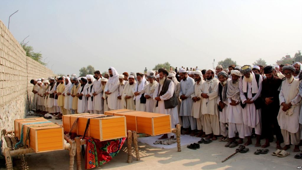Friends and family pray during a funeral procession for victims of a U.S. airstrike in the Nangarhar Province, Afghanistan. (Photo: Twitter @Qadir Sediqi‏)