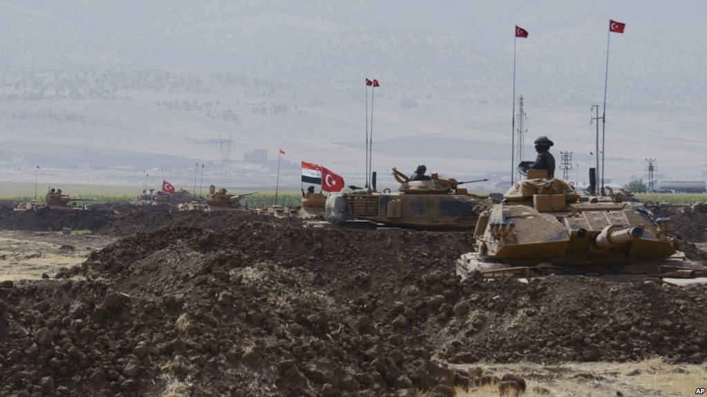 Turkish and Iraqi soldiers sit on Turkish tanks during the exercises in Silopi, near the Habur border gate with Iraq, southeastern Turkey, Sept. 26, 2017. (AP Photo)