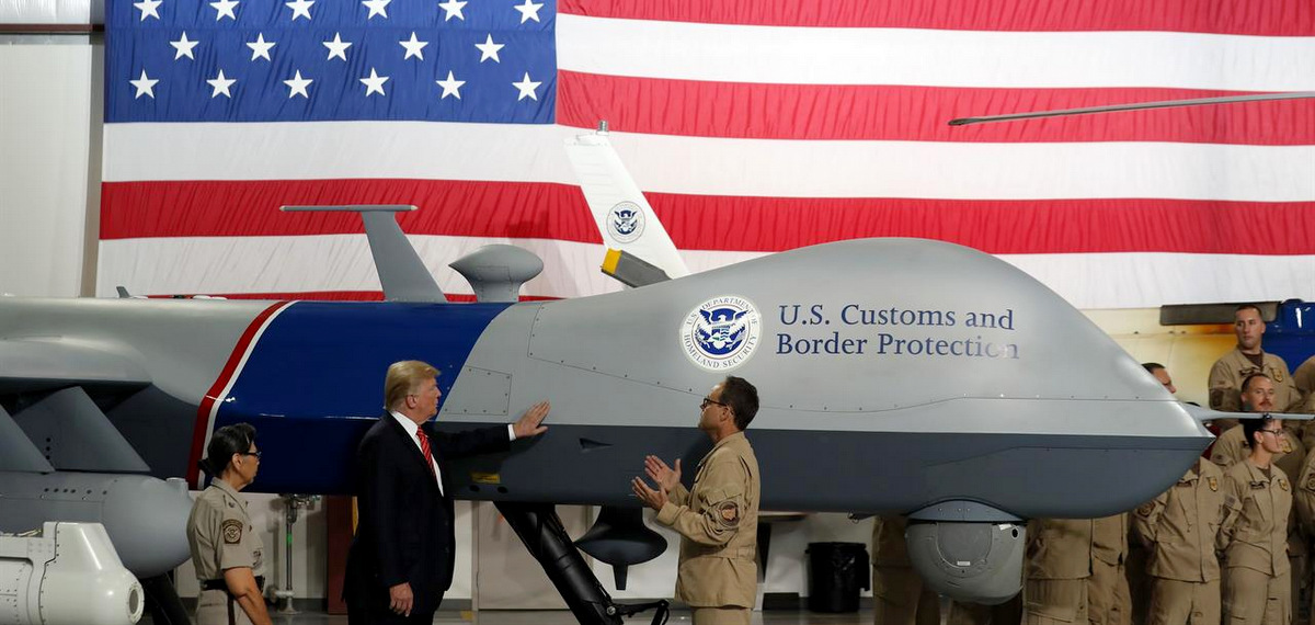 President Donald Trump touches a drone during a tour of U.S. Customs and Border Protection Border equipment at their airport hanger at Marine Corps Air Station Yuma, Tuesday, Aug. 22, 2017, in Yuma, Ariz. (AP Photo/Alex Brandon)