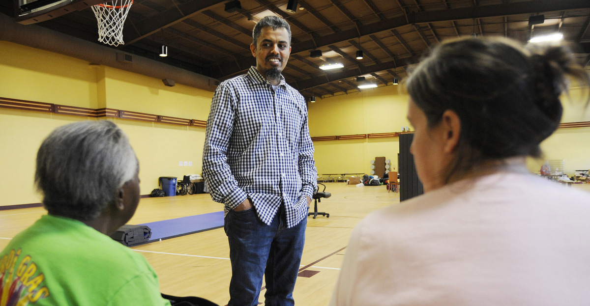 Ayman Kabire, a volunteer at Champions Mosque with the Islamic Society of Greater Houston, talks to evacuees at a mosque that was being used as a shelter. Houston's Muslim community, an estimated 200,000 people, has opened many of its community centers and sent hundreds of volunteers to serve food and deliver donations. Some have rescued neighbors from high water. (AP/Jay Reeves)