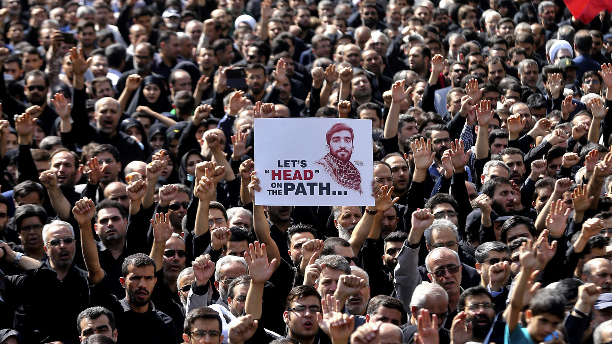 Thousands of Iranians attend the state funeral of Mohsen Hojaji, a young Revolutionary Guard soldier beheaded by ISIS in Syria, in Tehran, Iran, Wednesday, Sept. 27, 2017. The death of 25-year-old Mohsen Hojaji has struck a nerve in Iran, which has suffered casualties while its troops are deployed into Iraq fighting ISIS and in Syria. (AP/Ebrahim Noroozi)