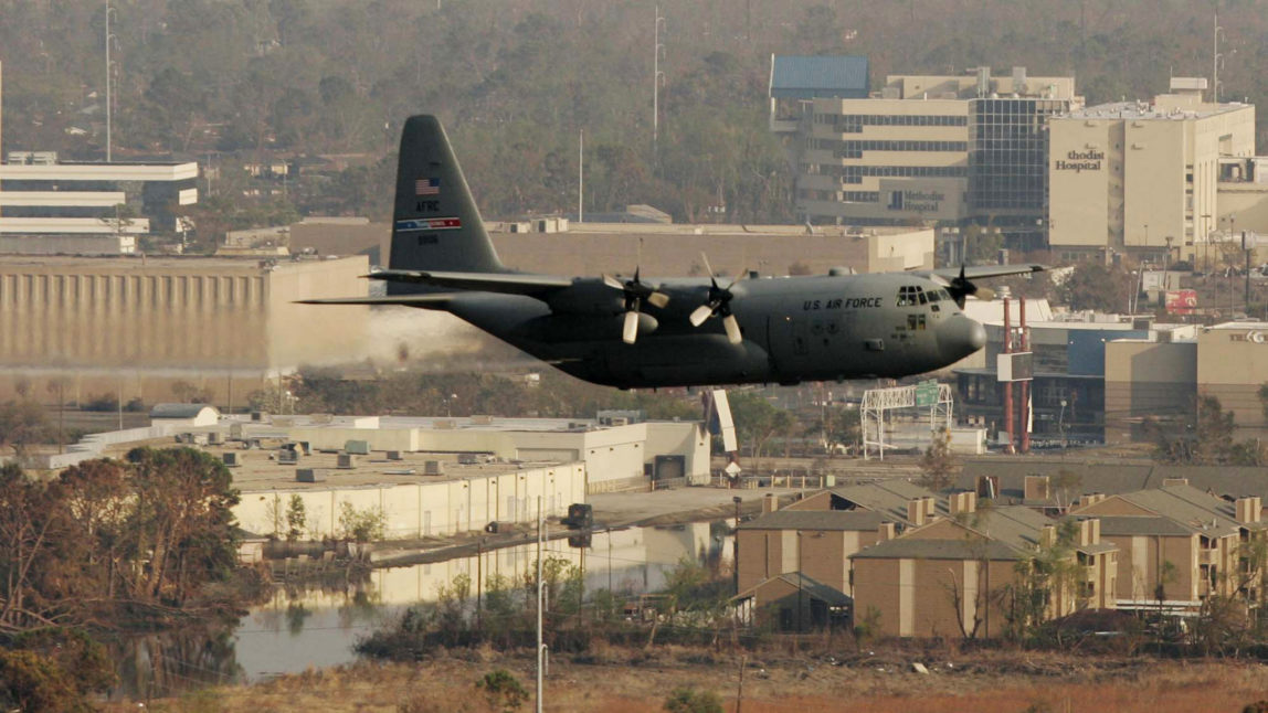 A military C-130 plane sprays pesticide over Hurricane Katrina damaged parts of New Orleans. (AP Photo/Brian Snyder)