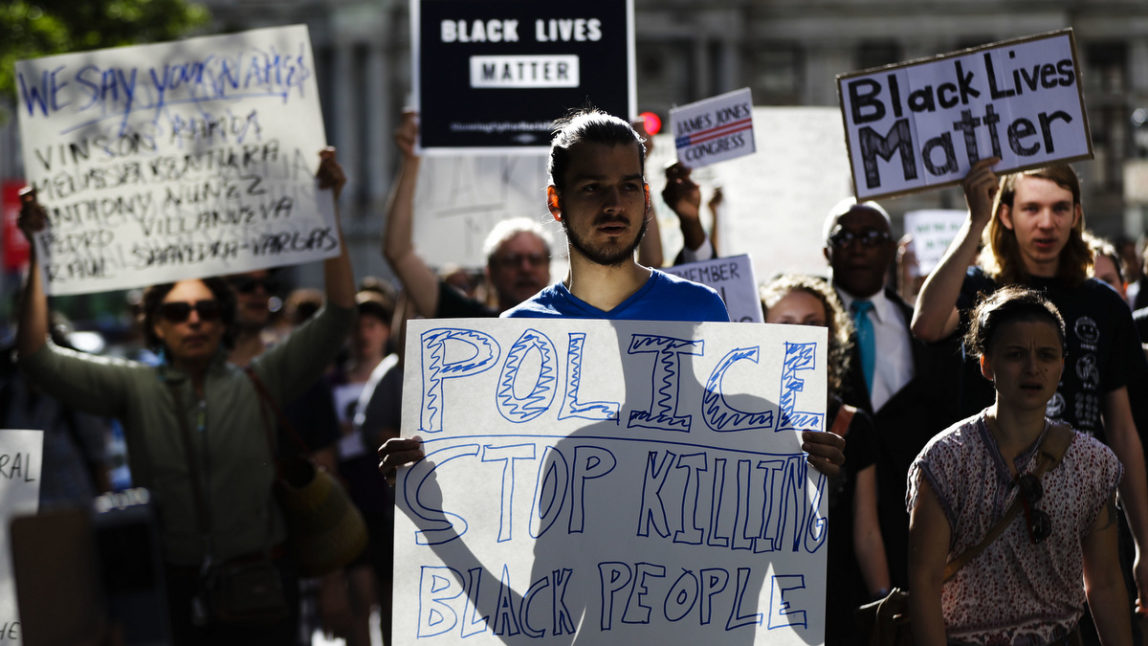 Protesters march and demonstrate to decry recent shootings of black men by police and urge reforms in front of City Hall in Philadelphia, July 11, 2016. (AP/Matt Rourke)