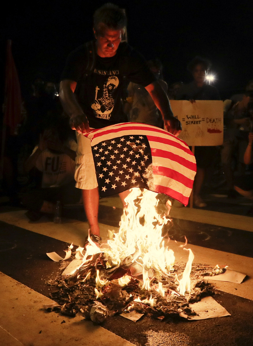A demonstrator burns an American flag during a protest in Philadelphia, July 26, 2016, during the second day of the Democratic National Convention. (AP/Matt Slocum)