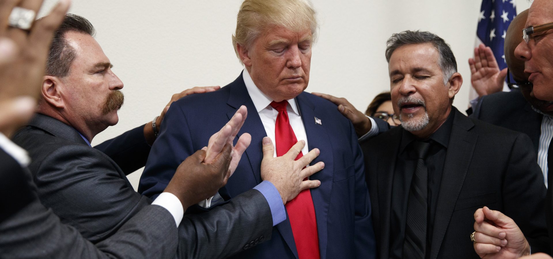 Pastors from the Las Vegas area pray with Republican presidential candidate Donald Trump during a visit to the International Church of Las Vegas, and International Christian Academy, Oct. 5, 2016, in Las Vegas. (AP Photo/ Evan Vucci)