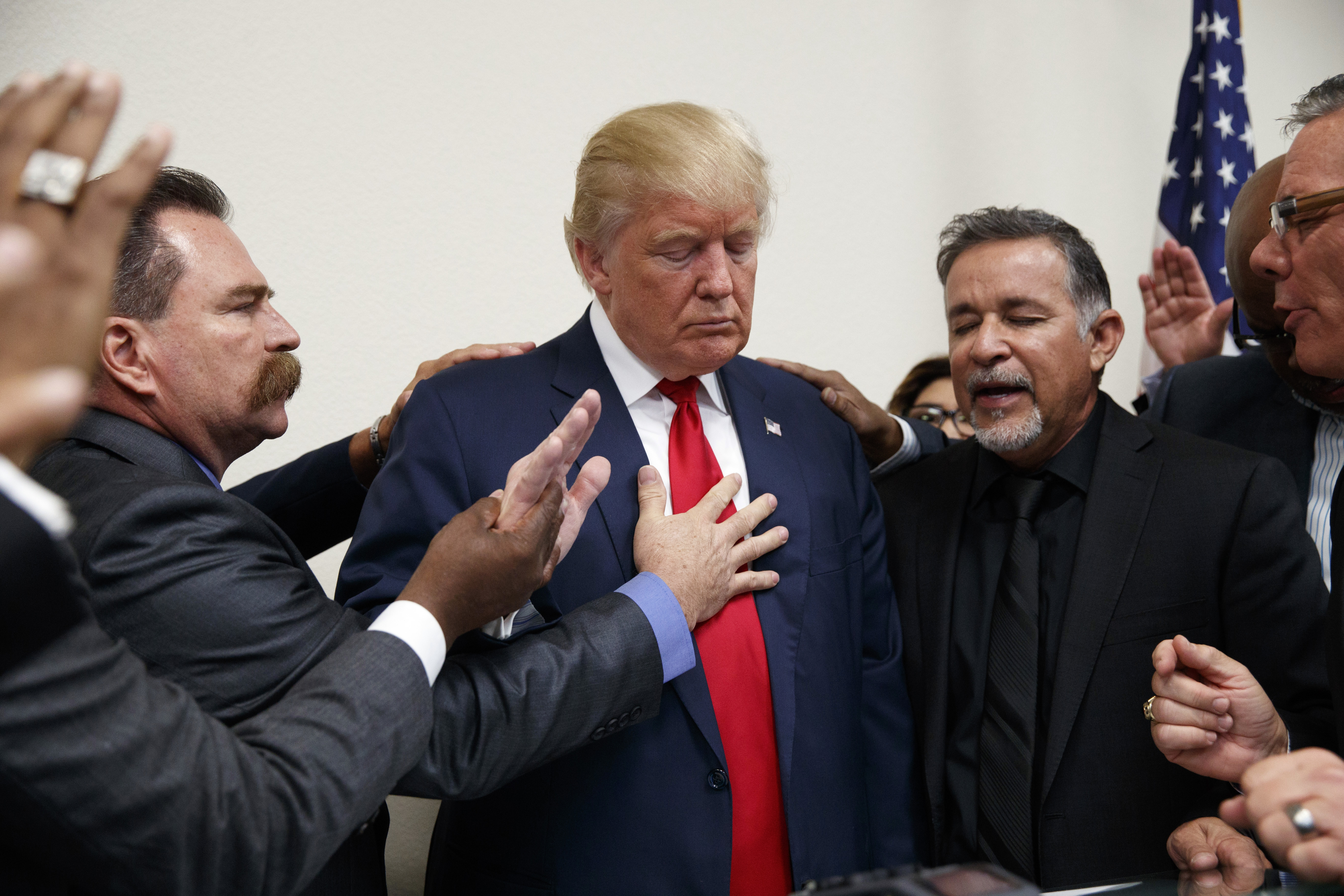 Pastors from the Las Vegas area pray with Republican presidential candidate Donald Trump during a visit to the International Church of Las Vegas, and International Christian Academy, Oct. 5, 2016, in Las Vegas. (AP Photo/ Evan Vucci)