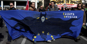 Protesters hold a banner during a rally in Athens, Thursday, Dec. 8, 2016. A nationwide 24-hour general strike called by unions against austerity measures disrupted public services across Greece on, while thousands marched in protest in central Athens. (AP/Yorgos Karahalis)