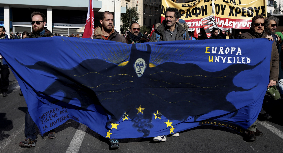 Protesters hold a banner during a rally in Athens, Thursday, Dec. 8, 2016. A nationwide 24-hour general strike called by unions against austerity measures disrupted public services across Greece on, while thousands marched in protest in central Athens. (AP/Yorgos Karahalis)