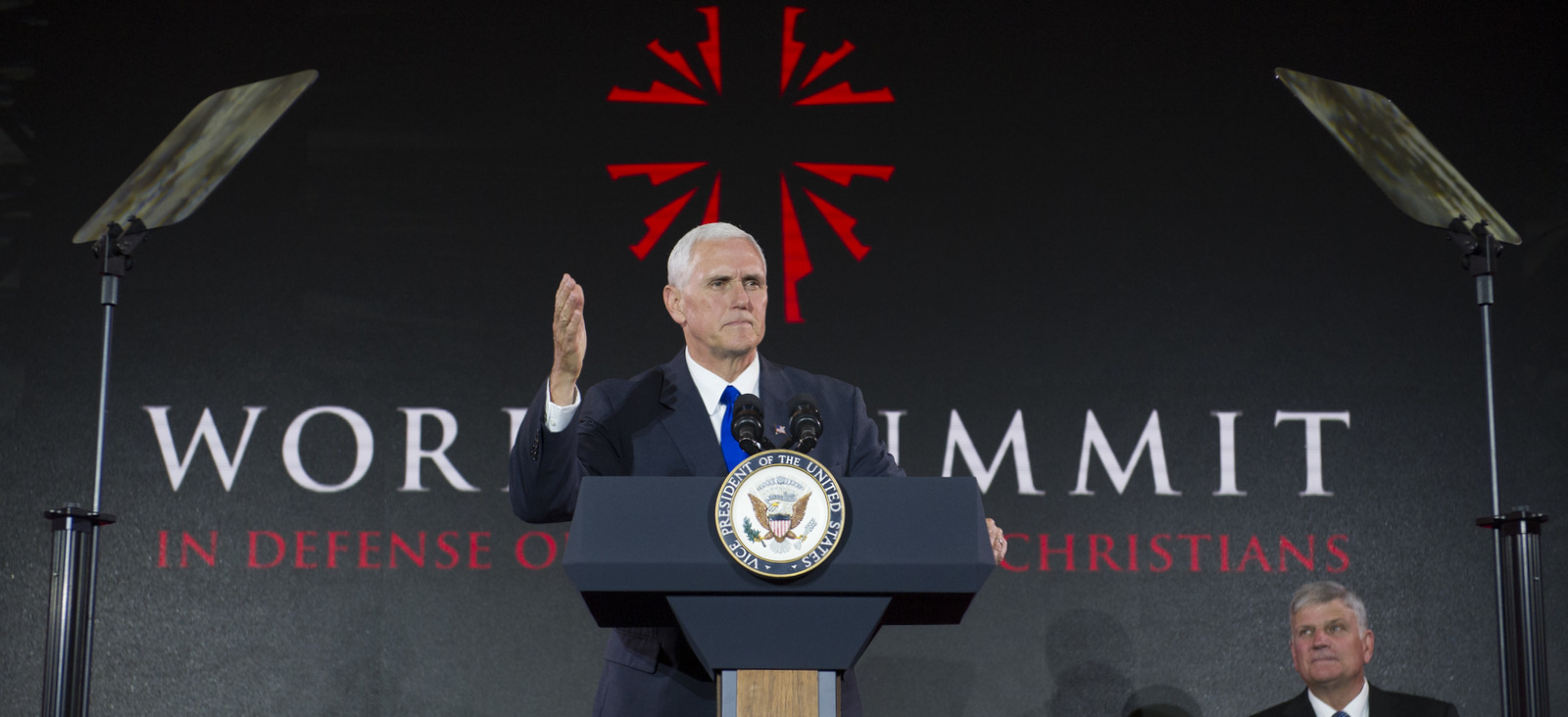 Vice President Mike Pence addresses the World Summit in Defense of Persecuted Christians as Franklin Graham watches, Thursday, May 11, 2017, in Washington. The summit was hosted by Franklin Graham, and the Billy Graham Evangelistic Association. (AP/Cliff Owen)
