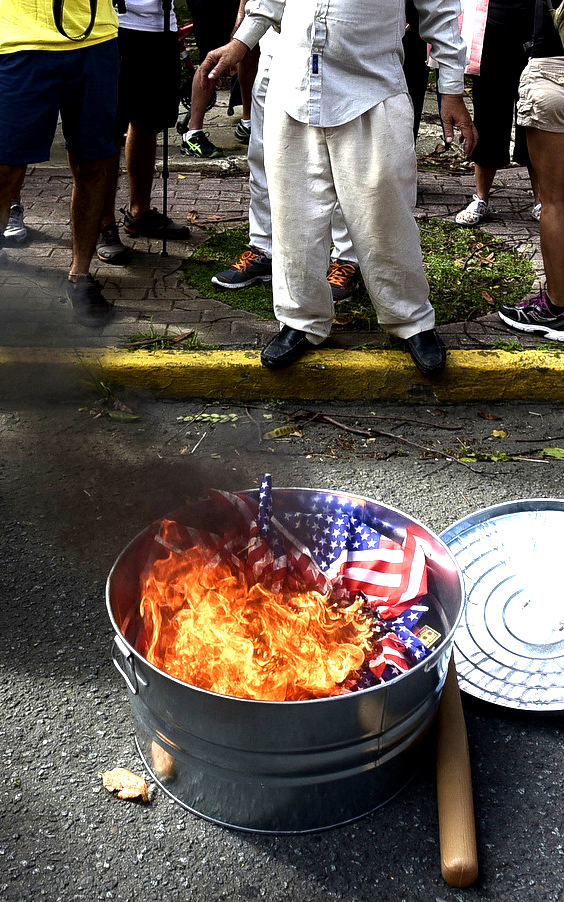 Protesters burn a U.S. flag in the financial district, known as the golden mile, in San Juan, Puerto Rico, June 11, 2017. (AP/Carlos Giusti)