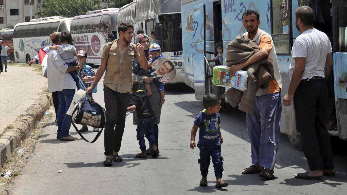 Syrians arriving from Jarablus, in Aleppo province, to their old neighborhood of al-Waer, in Homs, Syria, July 11, 2017. (SANA via AP)