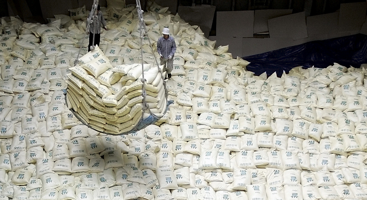 South Korean workers load packs of rice for North Korea into a Vietnamese ship at Gunsan port in Gunsan, South Korea. (AP/ Lee Jin-man)
