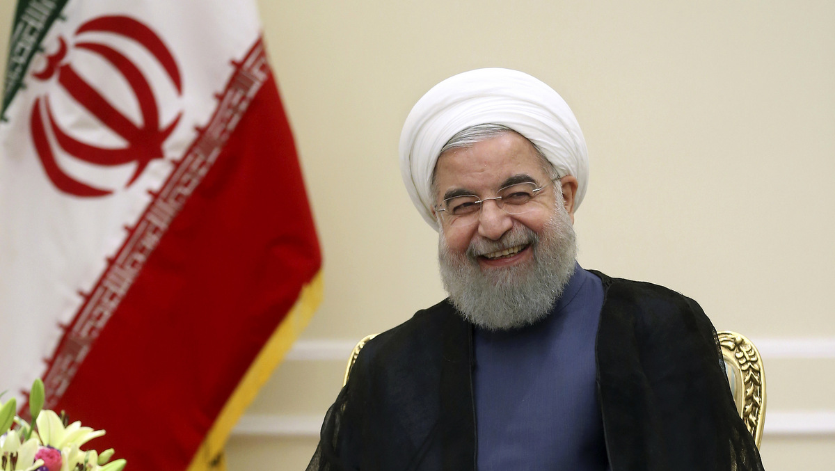 Iranian President Hassan Rouhani smiles during his meeting with Afghan President Ashraf Ghani at the presidency office in Tehran, Iran, Saturday, Aug. 5, 2017. According to IRNA official news agency, 100 foreign delegations including seven presidents and 18 parliament speakers are set to attend Rouhani's inauguration of his second term as president, a record in history of Iran after the 1979 Islamic Revolution. (AP/Ebrahim Noroozi)