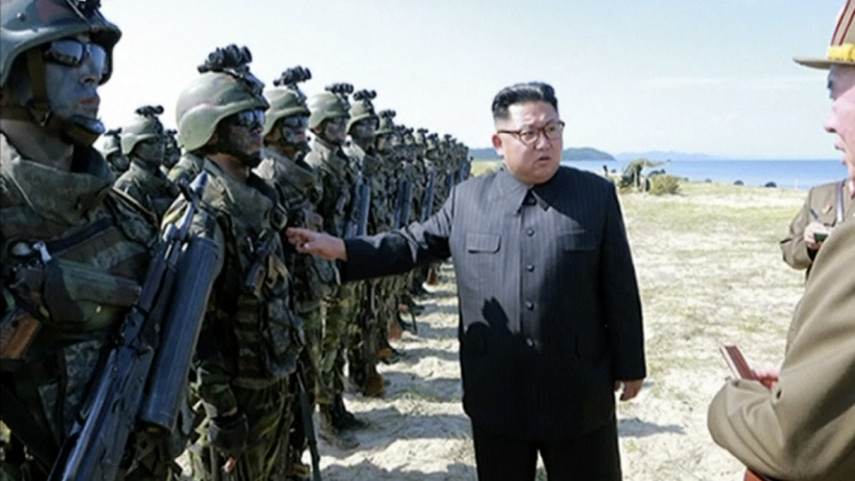 This image made from video aired by North Korea's KRT on Aug. 26, 2017 shows a photo of North Korean leader Kim Jong Un inspecting soldiers during what Korean Central News Agency called a "target=striking contest" at unknown location in North Korea. (KRT via AP Video)