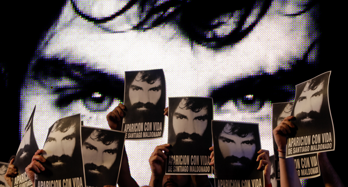 Demonstrators hold photos of missing activist Santiago Maldonado, during a protest at Plaza de Mayo in Buenos Aires, Argentina, Friday, Sept. 1, 2017. Human rights groups say Maldonado went missing a month ago, after Argentine border police captured him during an operation against Mapuche Indians who were blocking a highway in Argentina's Patagonia. (AP/Natacha Pisarenko)