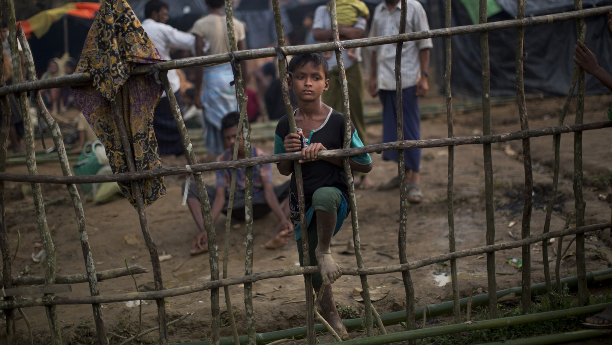 A Rohingya child, newly arrived from Myanmmar to the Bangladesh side of the border, stands by a wooden fence at Kutupalong refugee camp in Ukhia, Sept. 5, 2017. Bangladesh, one of the world's poorest countries, was already sheltering some 100,000 Rohingya refugees before another 123,000 flooded in after Aug. 25, according to the U.N. refugee agency's latest estimate on Tuesday. (AP/Bernat Armangue)