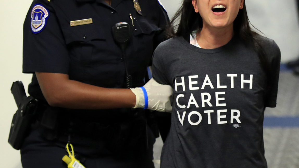 Protesters demanding affordable health care are arrested by U.S. capitol Police on Capitol Hill in Washington, Wednesday, Sept. 6, 2017. (AP/Manuel Balce Ceneta)