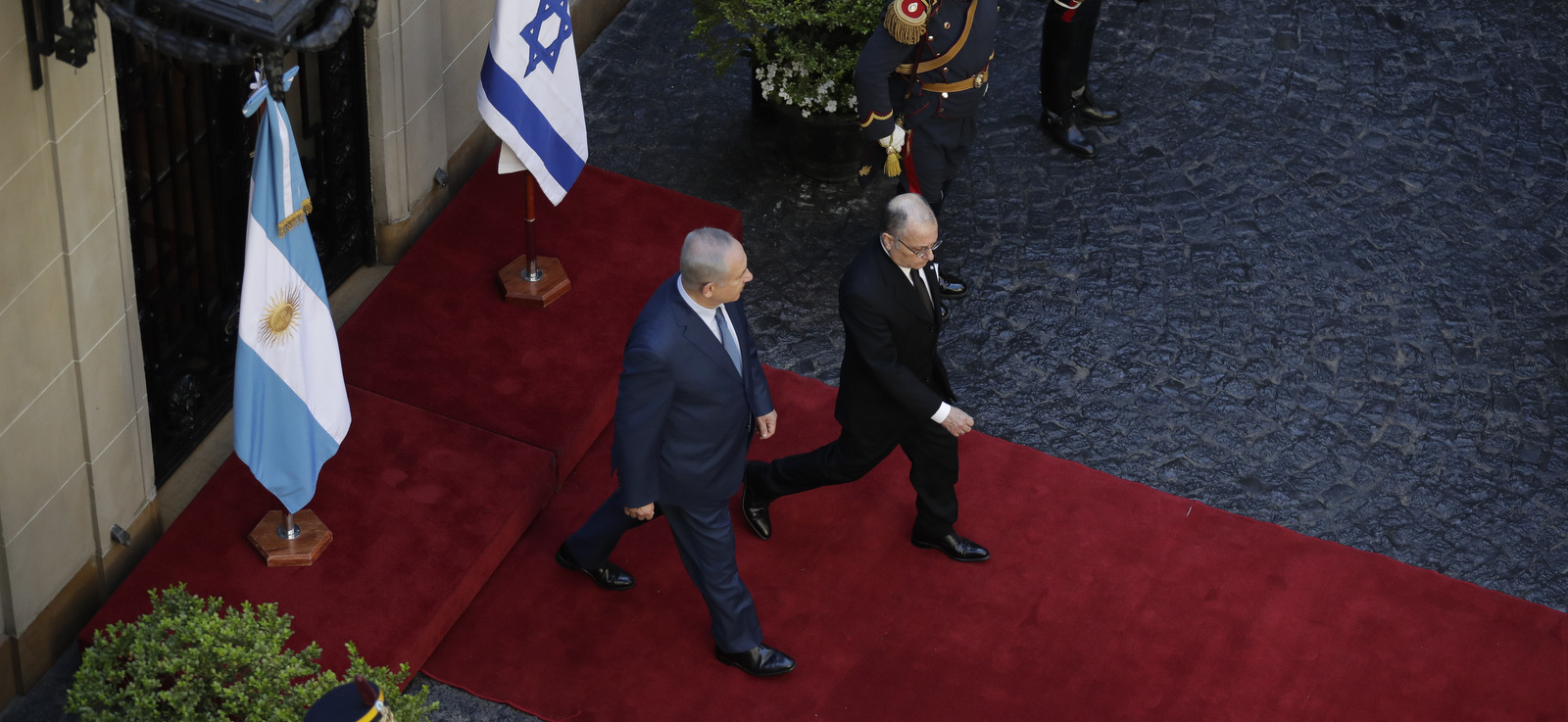 Israeli Prime Minister Benjamin Netanyahu, left, walks with Foreign Minister Jorge Faurie, right, inside the Argentine Foreign Minister Palace San Martin, in Buenos Aires, Argentina, Tuesday, Sept. 12, 2017. Netanyahu is on a two-day official visit to Argentina. (AP Photo/Victor R. Caivano)