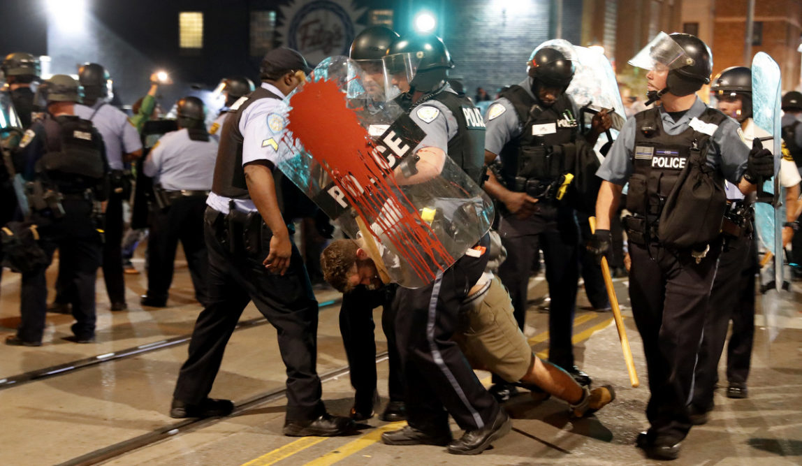 Police arrest a man as they try to clear a crowd Saturday, Sept. 16, 2017, in University City, Mo. Earlier, protesters marched peacefully in response to a not guilty verdict in the trial of former St. Louis police officer Jason Stockley. (AP/Jeff Roberson)