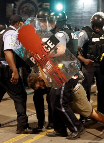 Police arrest a man as they try to clear a crowd Saturday, Sept. 16, 2017, in University City, Mo. Earlier, protesters marched peacefully in response to a not guilty verdict in the trial of former St. Louis police officer Jason Stockley. (AP/Jeff Roberson)
