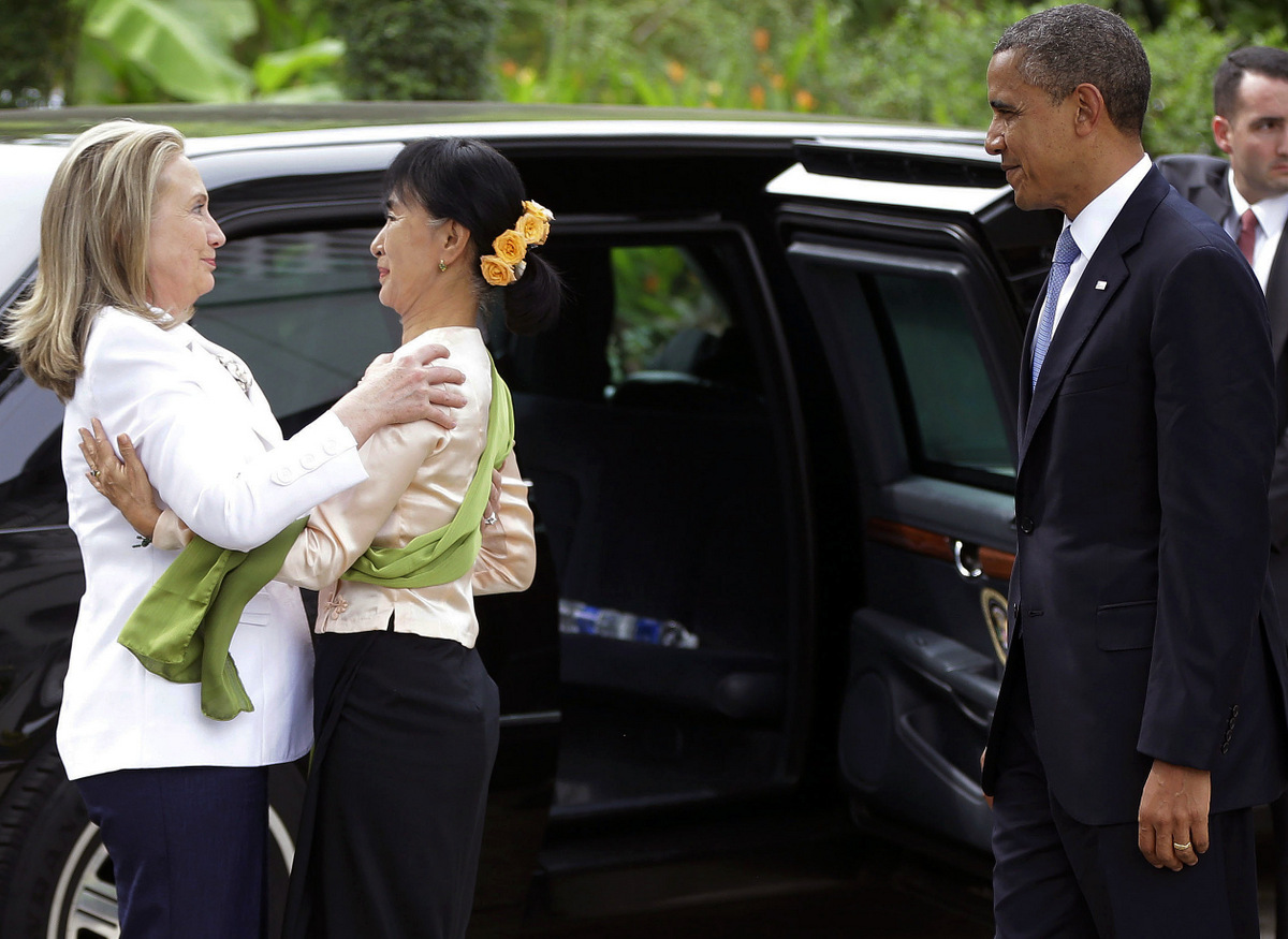 U.S. President Barack Obama, right, watches as Myanmar democracy activist Aung San Suu Kyi, center, greets U.S. Secretary of State Hilary Rodham Clinton at her residence in Yangon, Myanmar, Monday, Nov. 19, 2012. Obama is the first sitting U.S. president to visit the Asian nation. (AP/Pablo Martinez Monsivais)