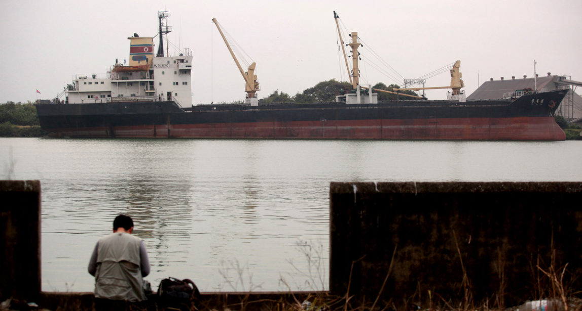 A journalist sits near the North Korean cargo ship Mu Du Bong, anchored in the port of Tuxpan, Mexico. Despite North Korea's protests, a panel of experts that monitors sanctions against Pyongyang for its nuclear and missile programs asked the Mexican government not to release the boat. (AP/Felix Marquez)