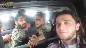 Muawiya Hassan Agha takes a selfie with two captured and condemned SAA soldiers who were later publicly tortured and executed. Agha posted related footage to his Facebook page that was later deleted.