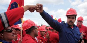 Venezuelan President Nicolas Maduro fist bumps a worker of the state-run oil company PDVSA during a visit to the Orinoco oil belt in Venezuela in 2013. (Photo: Miraflores/AP)