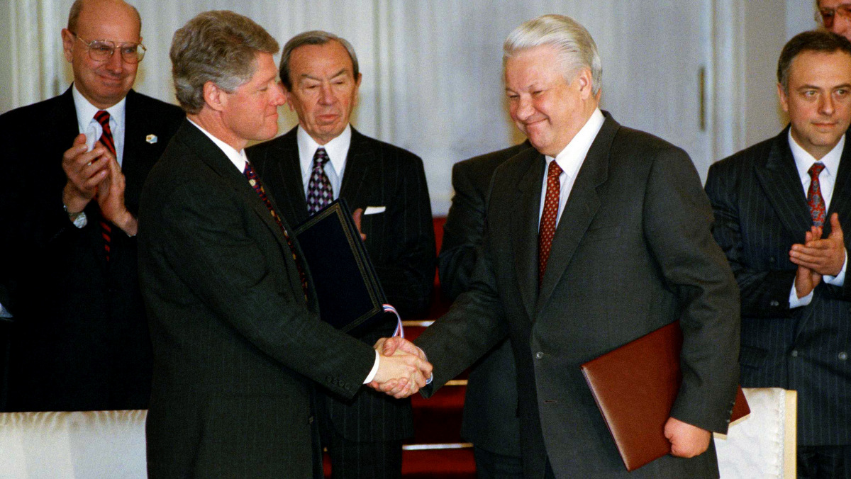U.S. President Bill Clinton shakes hands with Russian President Boris Yeltsin, right, as U.S. Secretary of State Warren Christopher looks on following their exchange of documents signed in the Kremlin, Jan. 14, 1994 agreeing to stop aiming long range nuclear missiles at each other's countries. (AP/Greg Gibson)