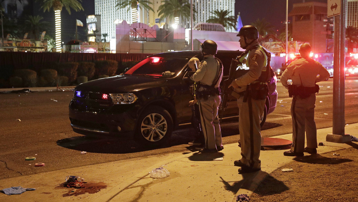 Police stand at the scene of a shooting along the Las Vegas Strip, Monday, Oct. 2, 2017, in Las Vegas. Multiple victims were being transported to hospitals after a shooting late Sunday at a music festival on the Las Vegas Strip. (AP/John Locher)