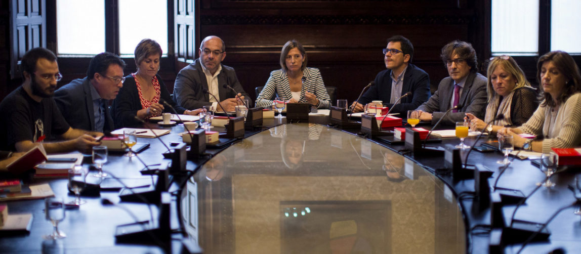 President of the Catalan parliament Carme Forcadell, center, attends a meeting with parliament representatives at the Catalonia Parliament in Barcelona, Spain, Oct. 4, 2017. Catalonia's regional government is mulling when to declare the region's independence from Spain in the wake of a disputed referendum that has triggered Spain's most serious national crisis in decades. (AP Photo/Emilio Morenatti)