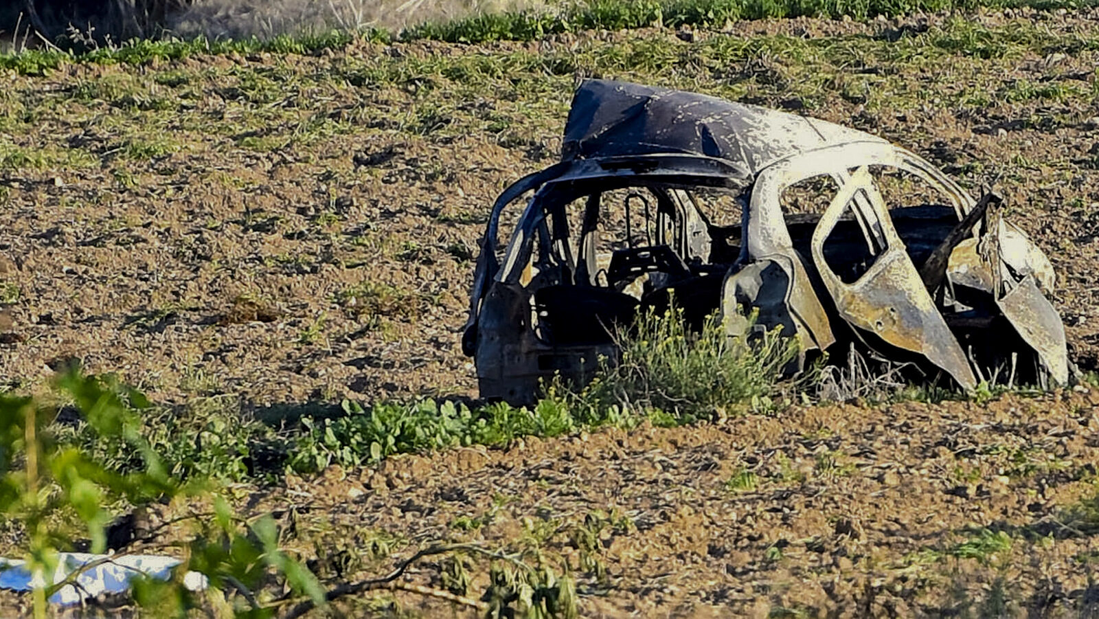 The wreckage of the car of investigative journalist Daphne Caruana Galizia lies next to a road in the town of Mosta, Malta, Monday, Oct. 16, 2017. Malta's prime minister says a car bomb has killed an investigative journalist on the island nation. Prime Minister Joseph Muscat said the bomb that killed reporter Daphne Caruana Galizia exploded Monday afternoon as she left her home in a town outside Malta's capital, Valetta. (AP/Rene Rossignaud)