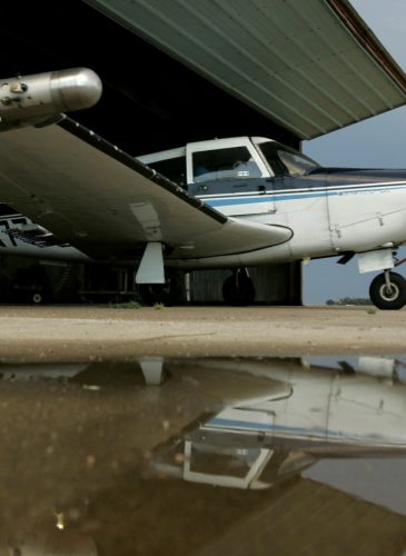 Scott Bryant pushes his plane into a hangar at the Lakin, Kan., airport after flying a cloud seeding mission for the Western Kansas Weather Modification program, Aug. 28, 2007. The program aims to reduce crop damage from hail by saturating storm clouds with silver iodide particles. (AP/Charlie Riedel)